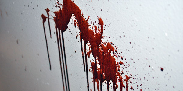 A wall surface with a small splash of fake blood dripping downward